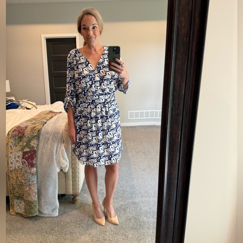 Long sleeved, knee length white and blue dress with pockets, size M.